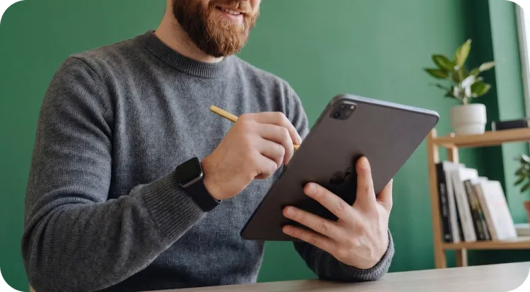 Men working on digital design with a graphic tablet in front of a computer.