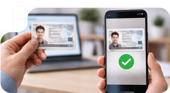 Hand holding an ID card next to a cell phone displaying the digital verification of the same document with a green confirmation icon