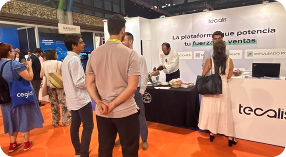 Attendees networking at the Tecalis booth during the Digital Enterprise Show (DES).