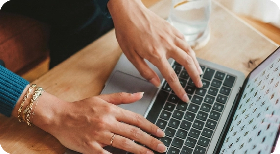 Professional working on a laptop managing long-term signatures.