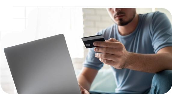 Boy with a computer making a card payment