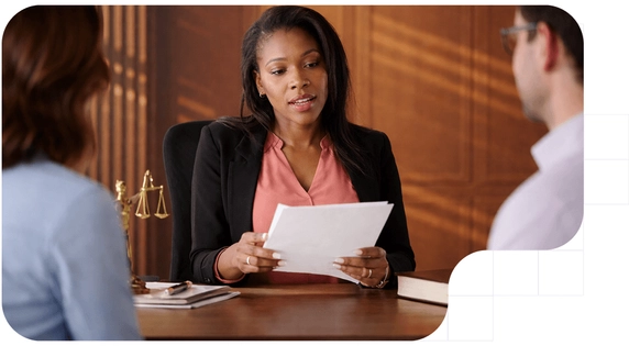 A lawyer reviewing documents with clients regarding the procedural efficiency law.