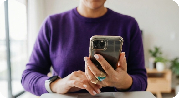 Person using a mobile phone with a login screen.