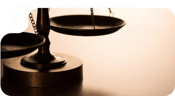 A detail of the scales of justice as a symbol of the new law on procedural efficiency.